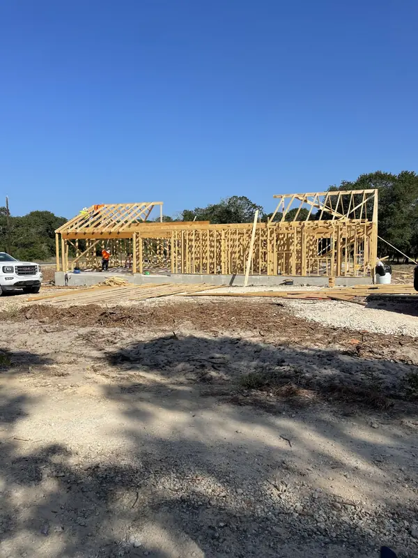 Roof trusses set on a new residential frame on a cleared lot