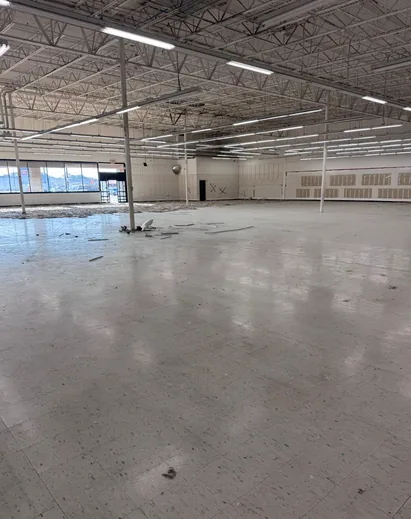 Vacant retail unit before work started, original tile floor intact and shopfront glazing in place