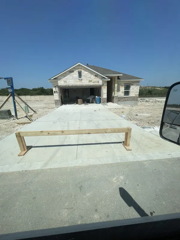 New home under construction with the concrete driveway poured