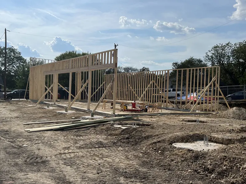 Wood framing skeleton of a new building on a graded lot