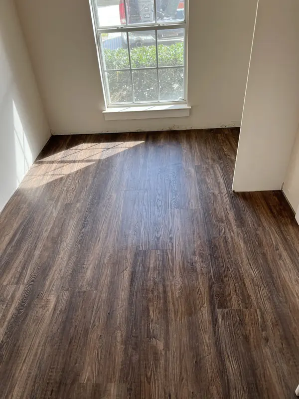 Dark walnut hardwood flooring installed in a bright living room