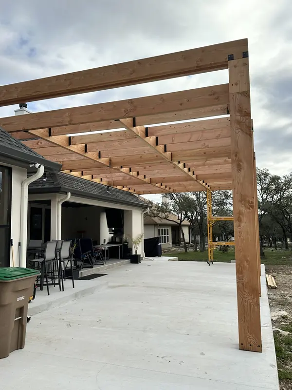 Finished cedar pergola over a furnished back patio