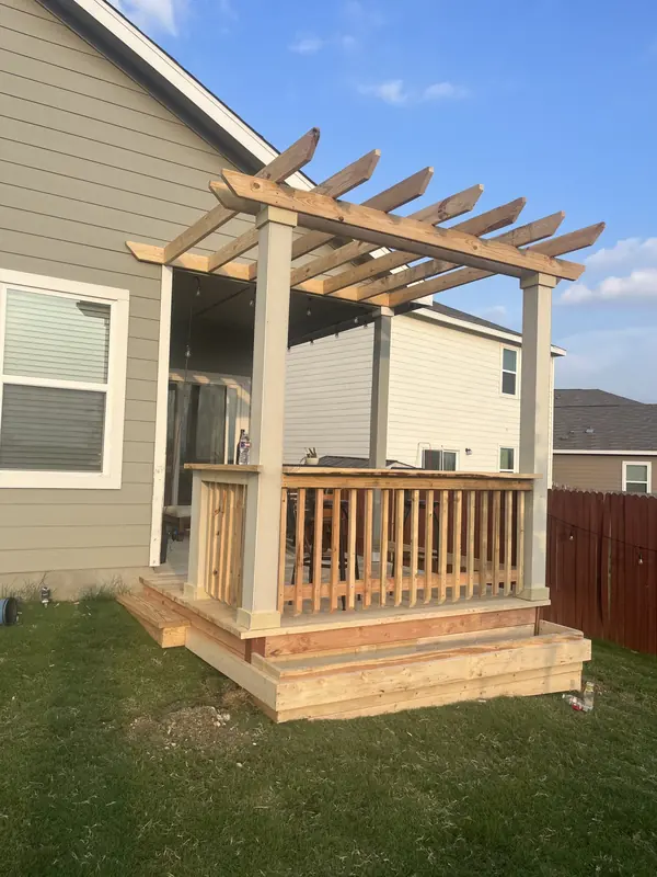 Cedar pergola and deck built off the back of a two storey home